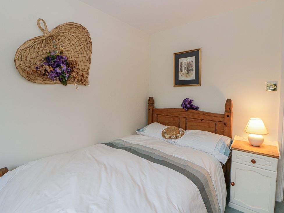 A bedroom with a bed and bedside table at Summerhill in Hereford