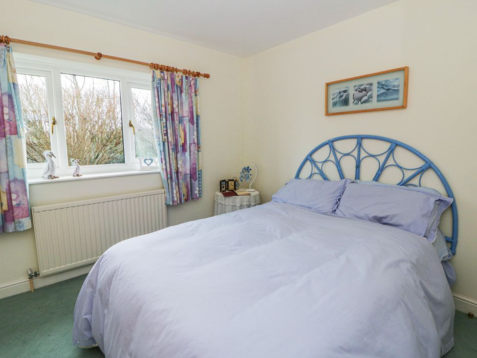 A bedroom with a bed and window at Summerhill in Hereford