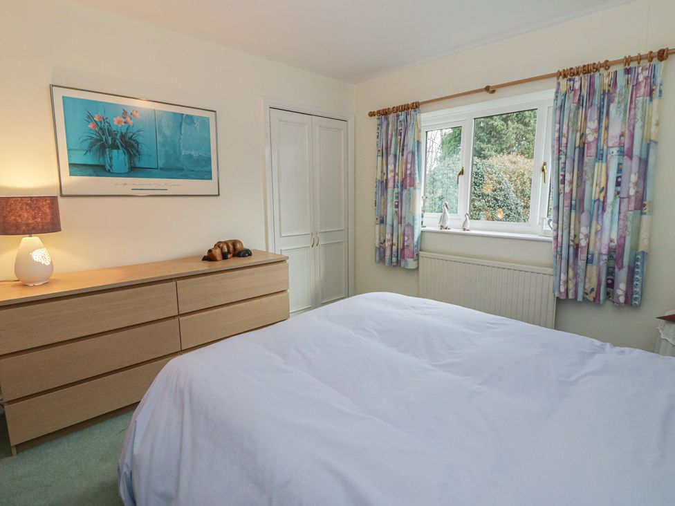 A bedroom with a bed and dresser at Summerhill Hereford