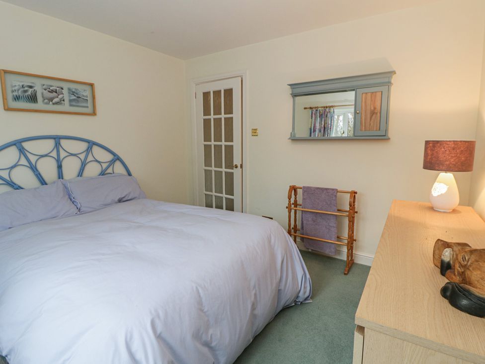A bedroom with a bed and dressing table at Summerhill in Hereford