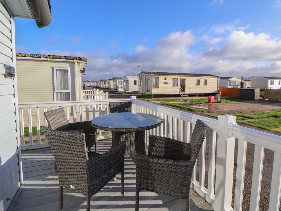 A patio with a table and chairs at CG 55 