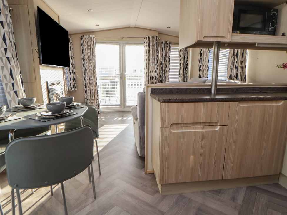 A living room with a table and chairs at CG 55