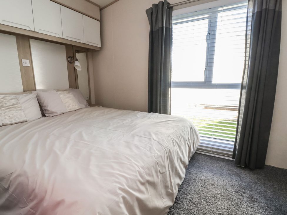 A bedroom with a bed and window at CG 55