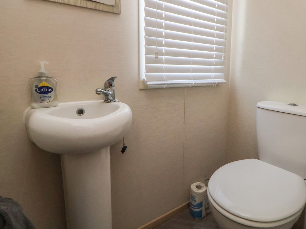 A bathroom with a sink and toilet at CG 55