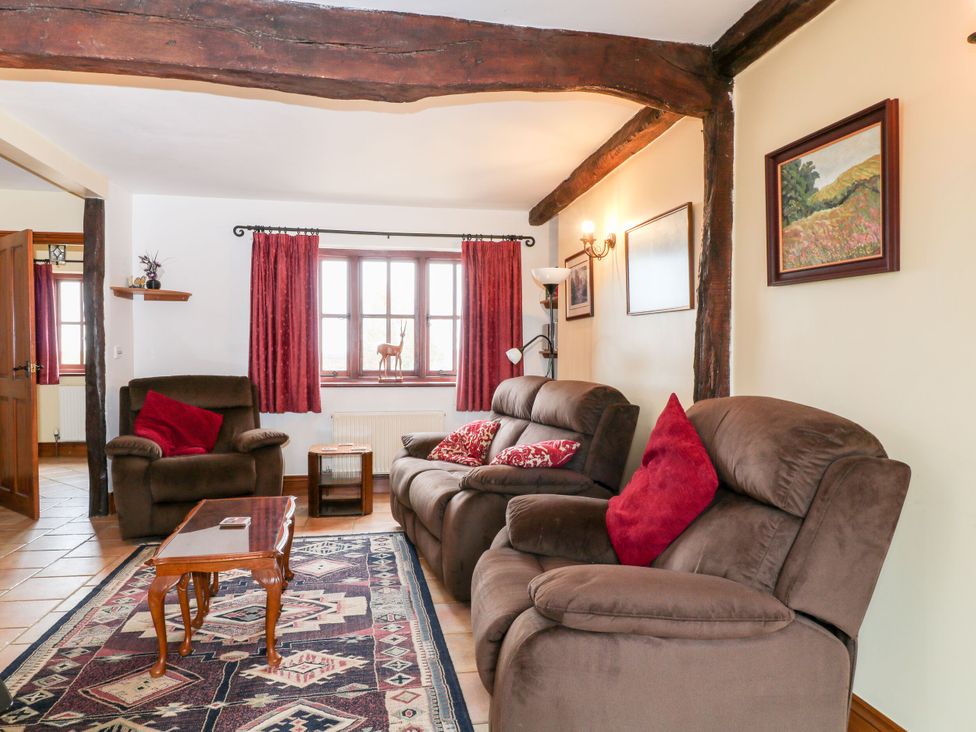 A living room with sofas and a coffee table at The Stables in Sturminster Newton