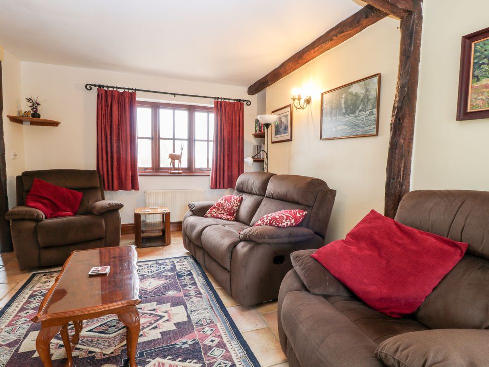 A living room with two sofas and a table at The Stables in Sturminster Newton