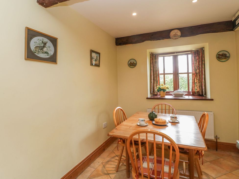 A dining room with a table and chairs at The Stables in Sturminster Newton