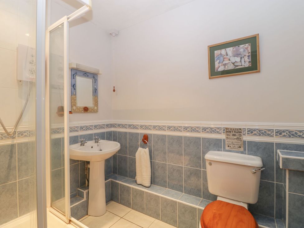 A bathroom with shower, sink and toilet at The Stables in Sturminster Newton