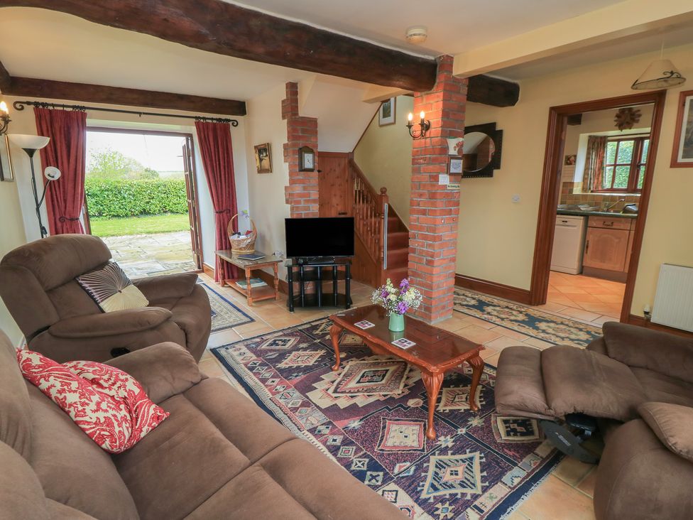 A living room with a sofa and coffee table at The Stables in Fifehead Neville near Hazelbury Bryan