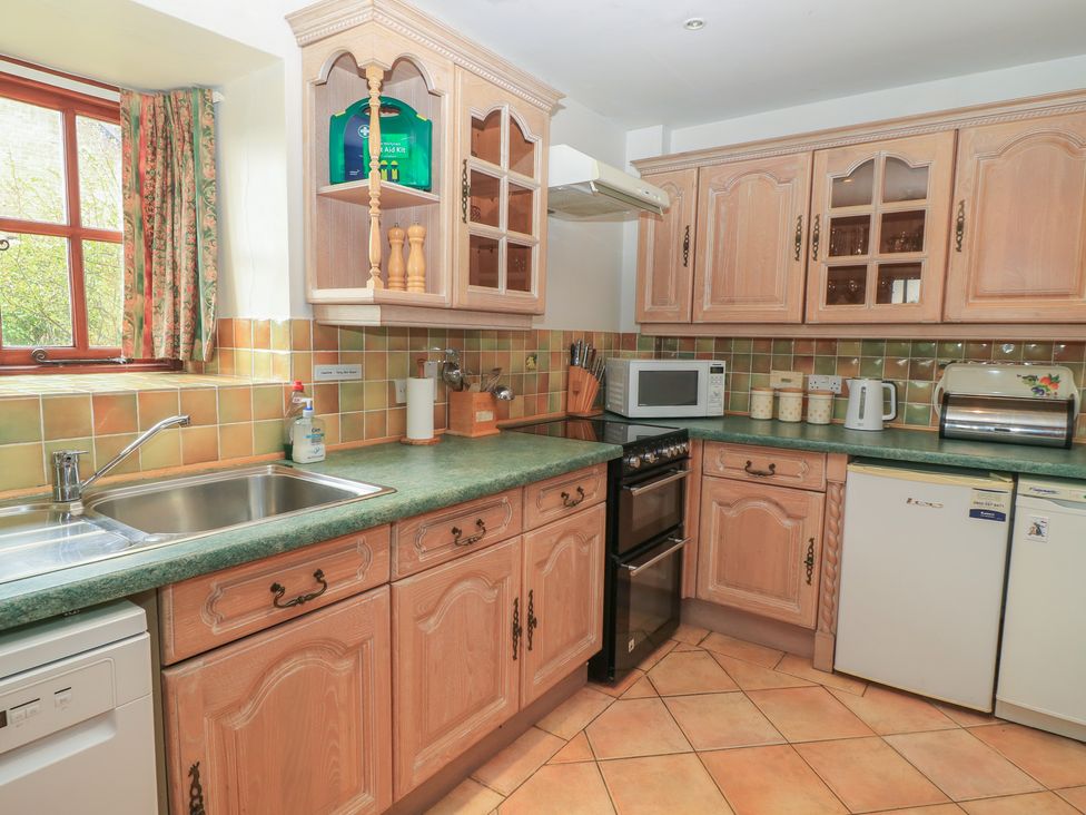 A kitchen with appliances and cabinets at The Stables in Fifehead Neville near Hazelbury Bryan