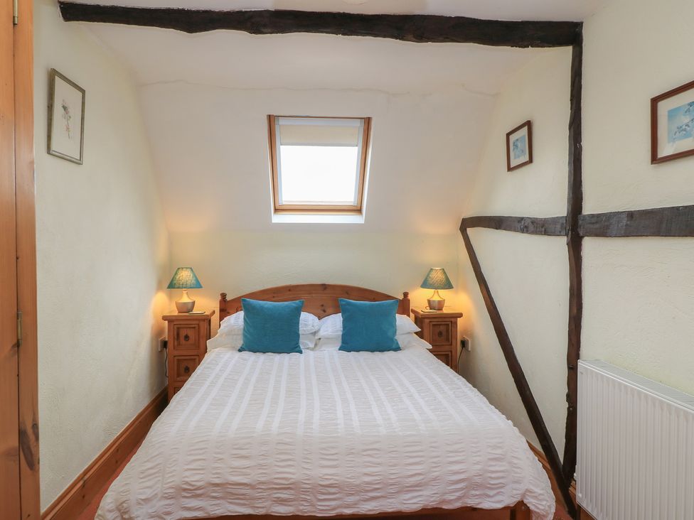 A bedroom with a double bed and window at The Stables in Fifehead Neville near Hazelbury Bryan