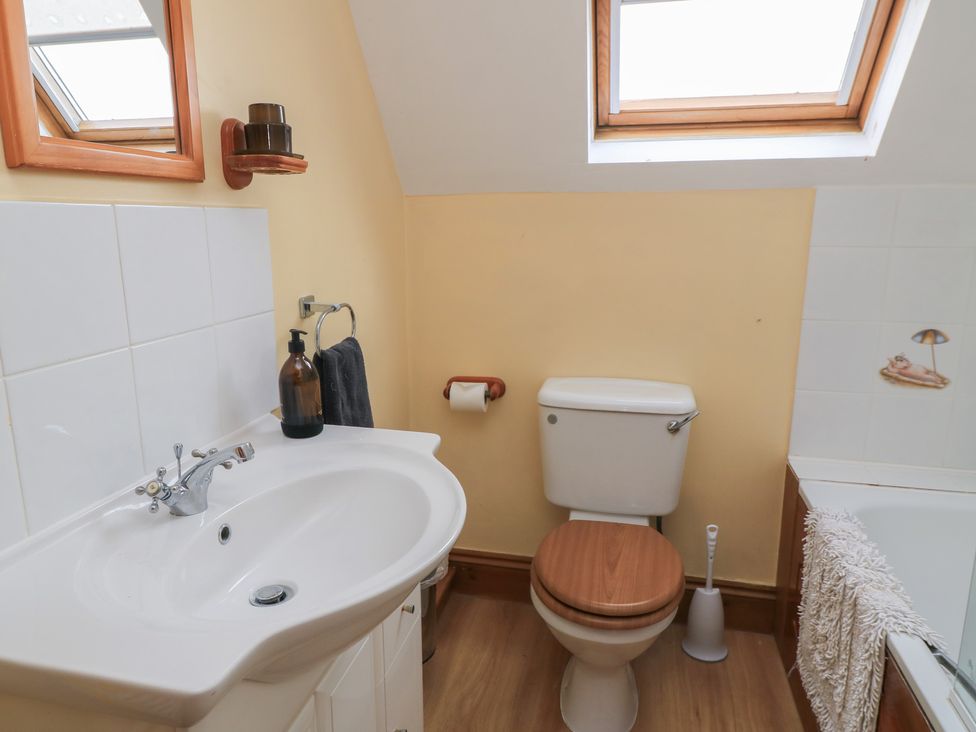 A bathroom with a sink, toilet, and bathtub at The Stables in Fifehead Neville near Hazelbury Bryan