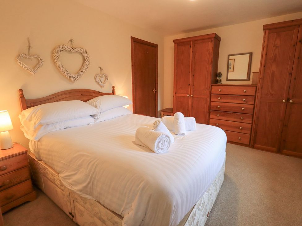 A bedroom with a bed and wooden furniture at Thrang View in Chapel Stile