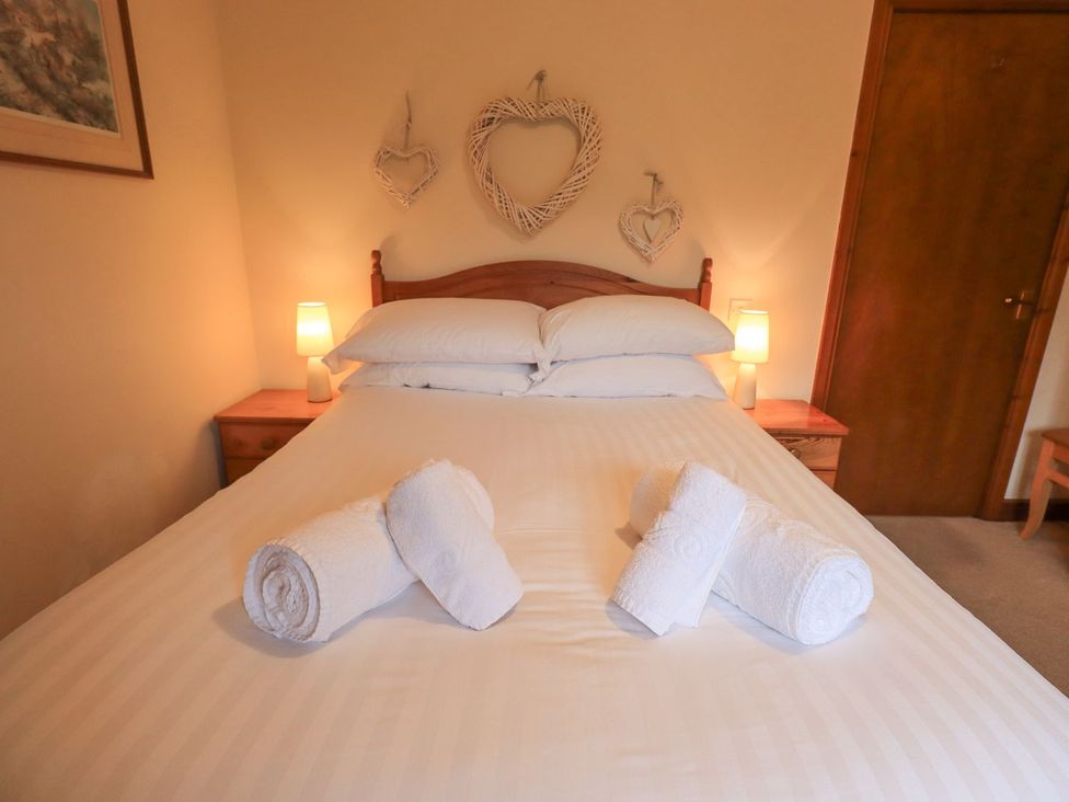 A bedroom with a bed and towels arranged on it at Thrang View in Chapel Stile