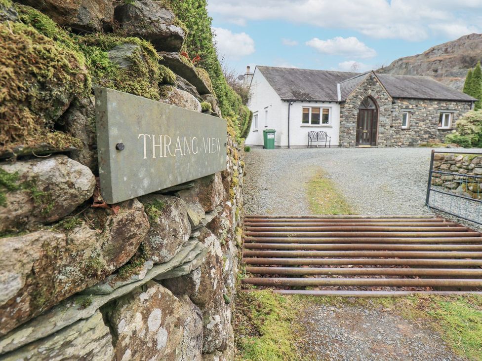 An entrance view with a stone wall and house at Thrang View in Chapel Stile