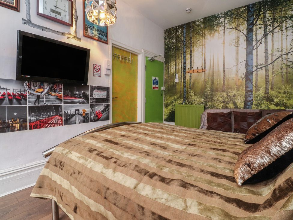 A bedroom with a bed and wall decor at Number 3 in Blackpool