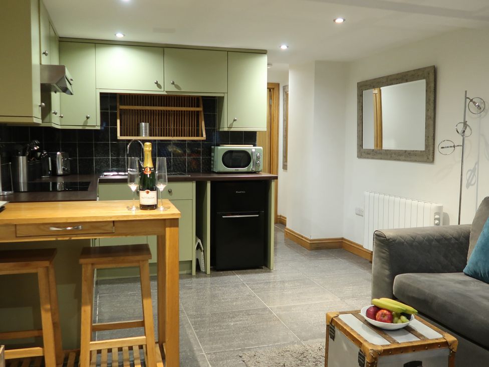 A kitchen with a countertop and modern appliances at Rockfish Cottage in Brixham