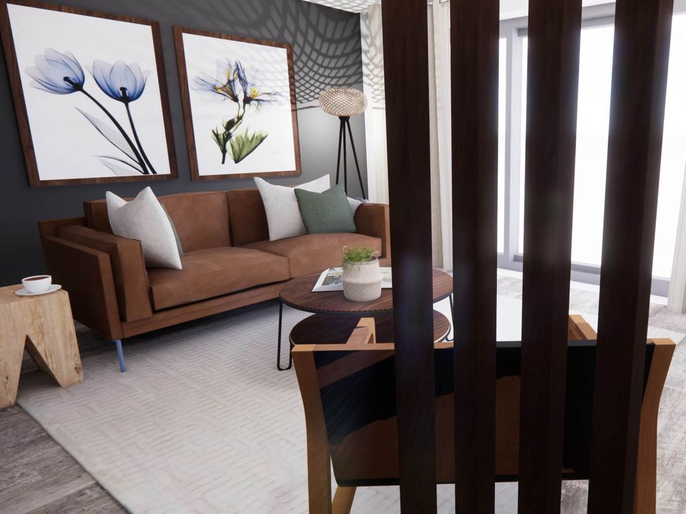 A living room with a sofa and artwork at Arvo Suite 1.0 Marhamchurch