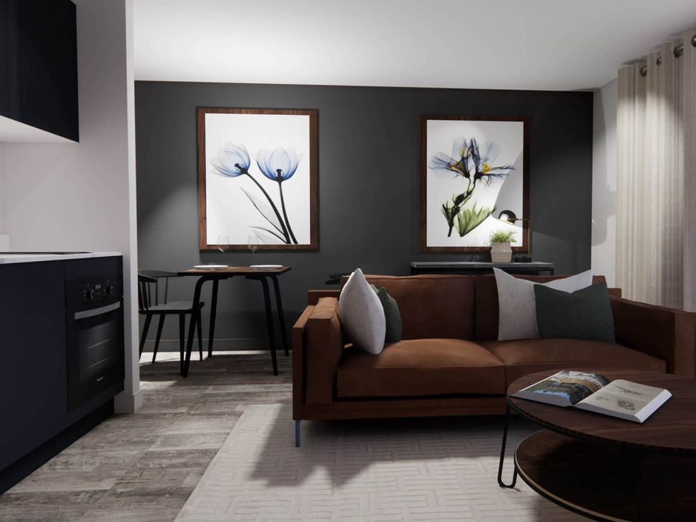 A living room with a sofa and dining area at Arvo Suite 1.0 Marhamchurch