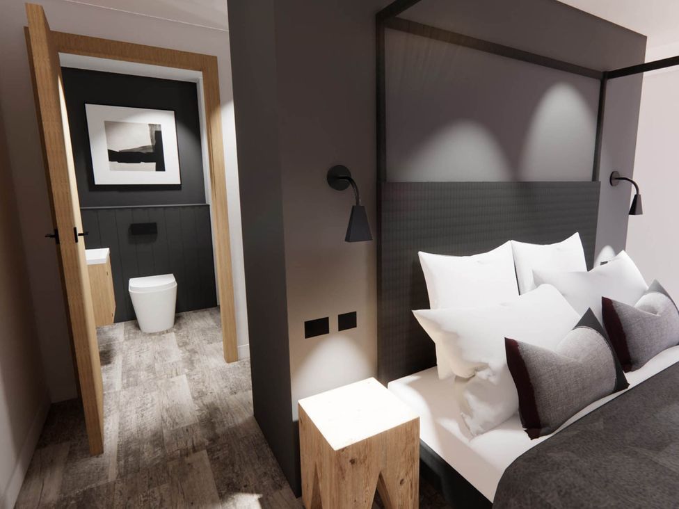 A bedroom with a bed and an ensuite bathroom at Arvo Suite 1.0 Marhamchurch