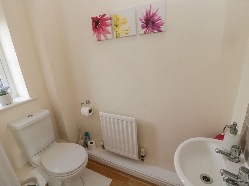 A bathroom with a toilet and sink at Ramblers Cottage in Alnwick