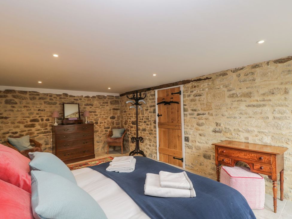 A bedroom with a bed and furniture at The Old Swill House in Foxham