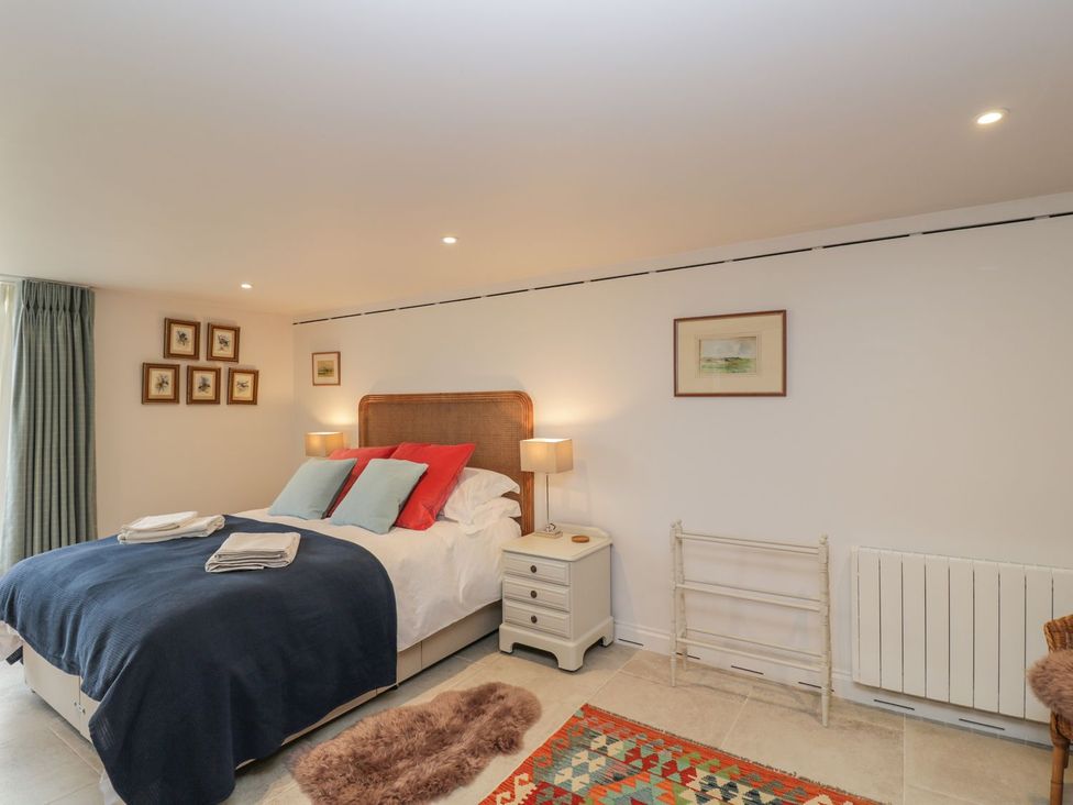 A bedroom with a bed and bedside table at The Old Swill House in Foxham