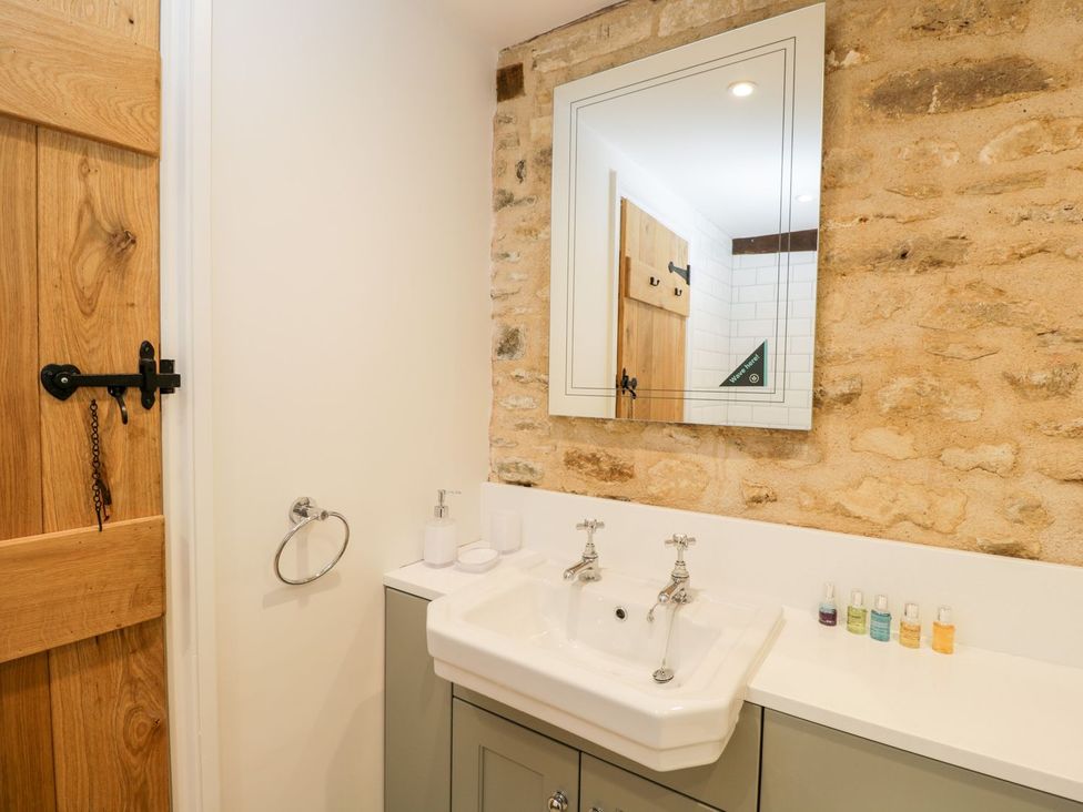A bathroom with a sink and mirror at The Old Swill House in Foxham