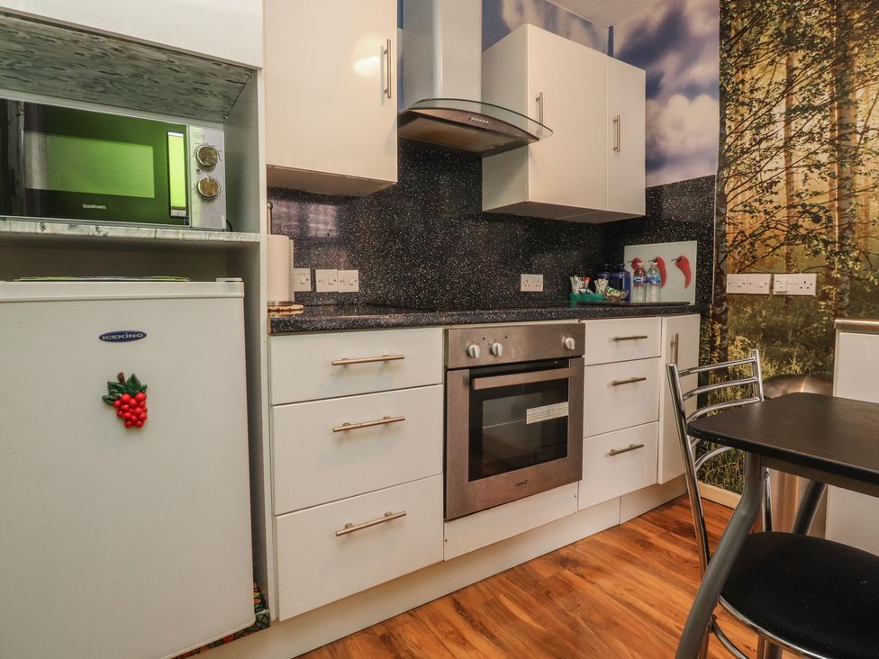 A kitchen with appliances and cabinets at Number 2 Blackpool