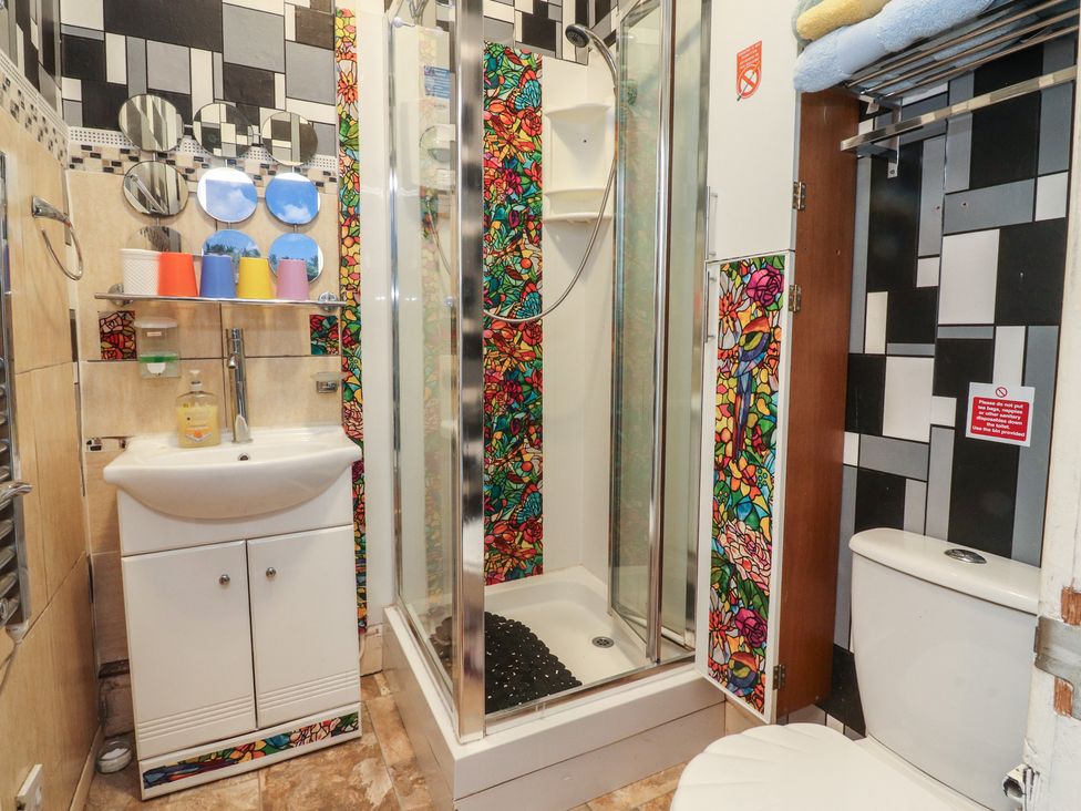 A bathroom featuring a shower, sink, and toilet at Number 6 Blackpool