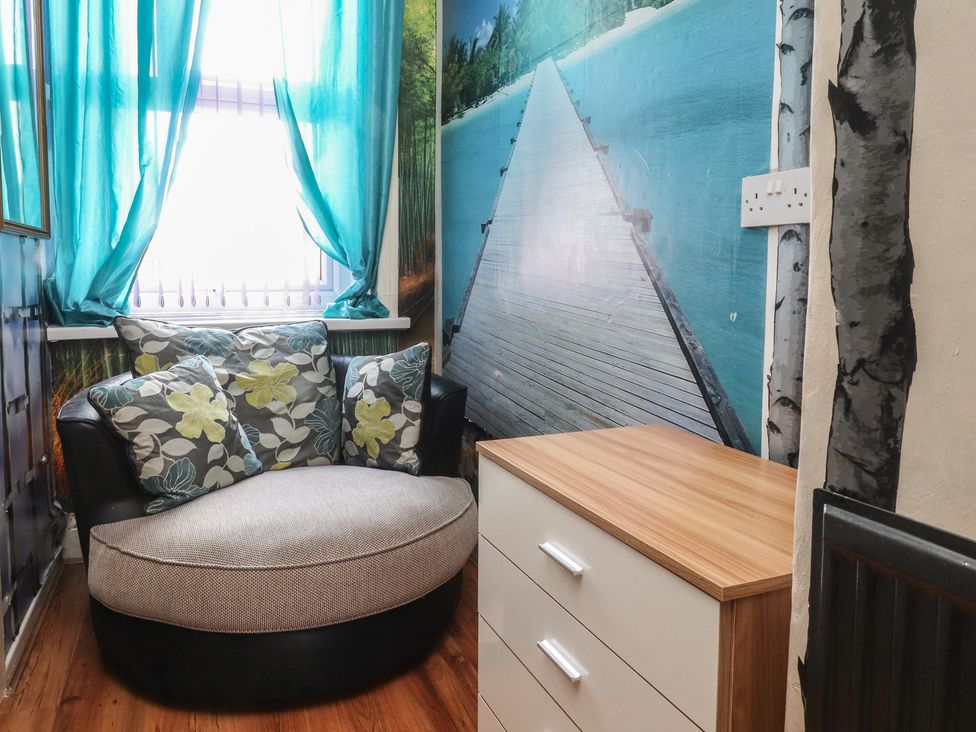 A sitting room with a sofa and a chest of drawers at Number 6 in Blackpool