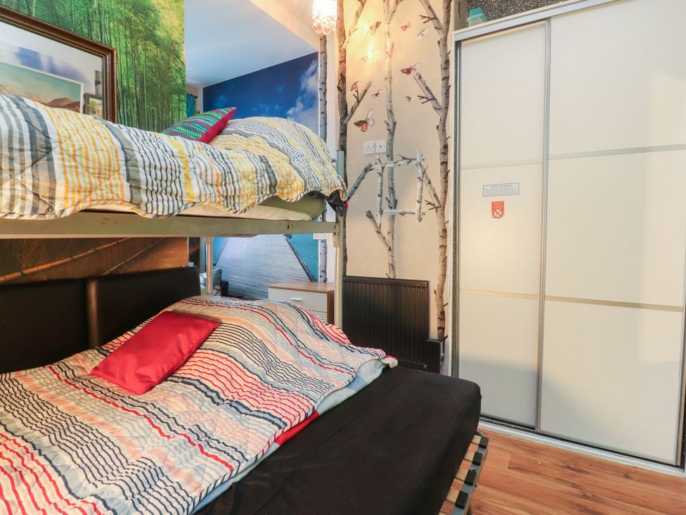 A bedroom with a bunk bed and wardrobe at Number 6 in Blackpool