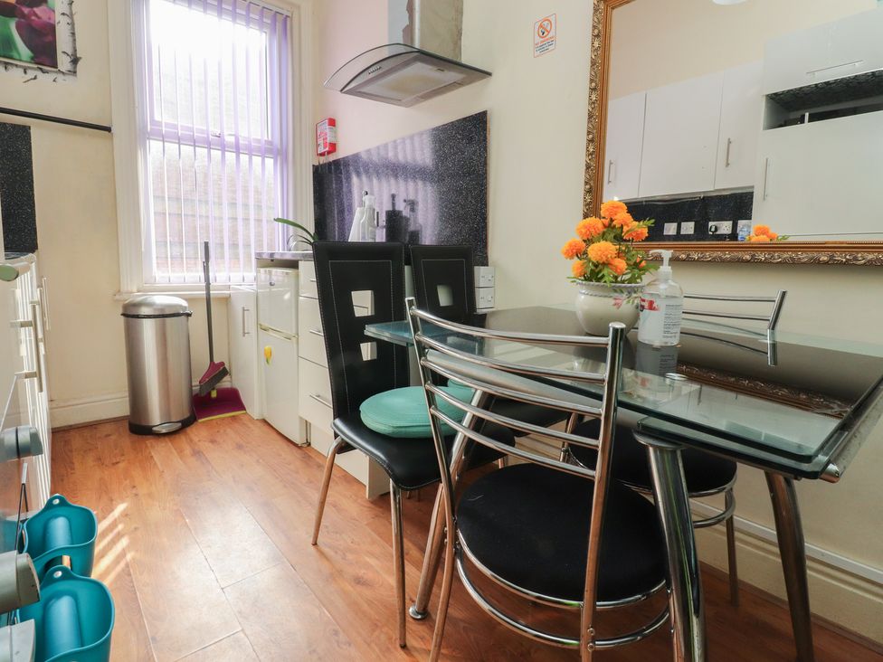 A kitchen with a dining table and chairs at Number 6 in Blackpool