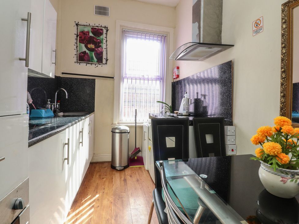 A kitchen with a table and chairs at Number 6 in Blackpool