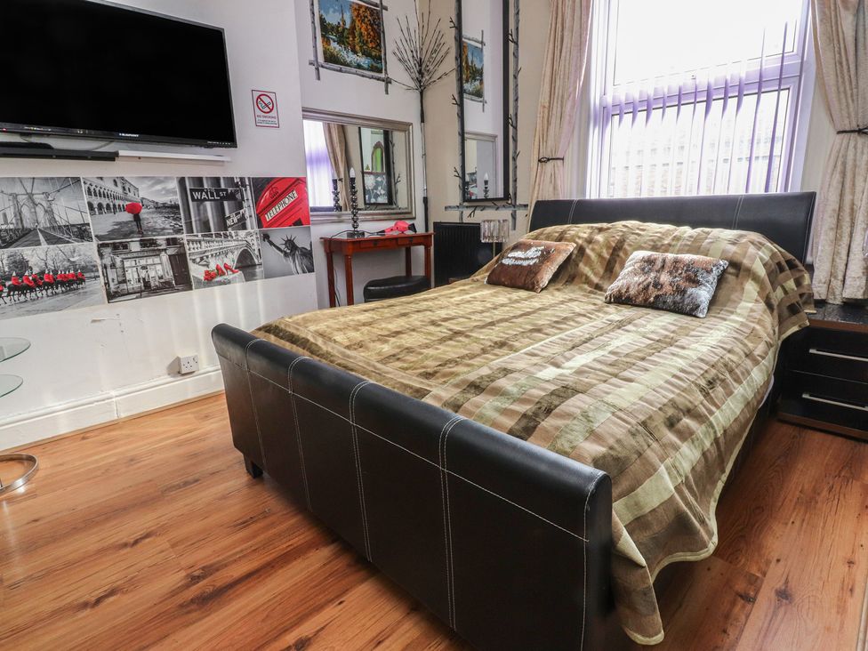 A bedroom with a bed and television at Number 6 in Blackpool