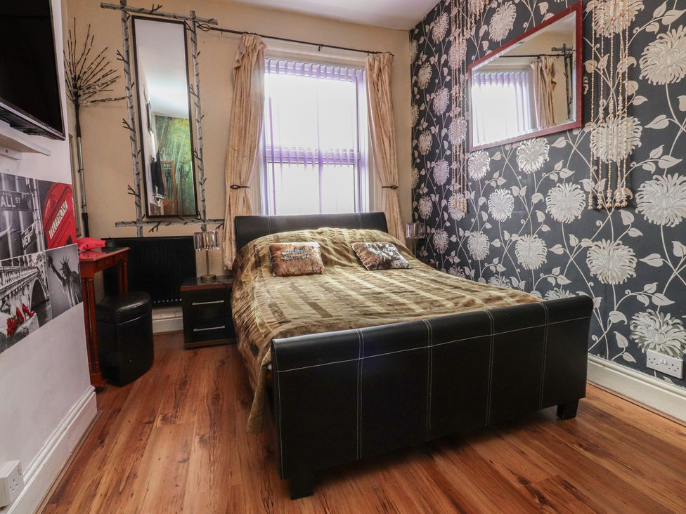 A bedroom with a bed and mirror at Number 6 in Blackpool