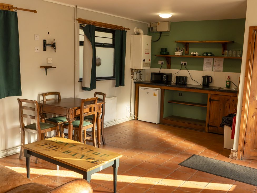A kitchen with dining table and chairs at 2 Bedroom Chalet No.2 Port Talbot