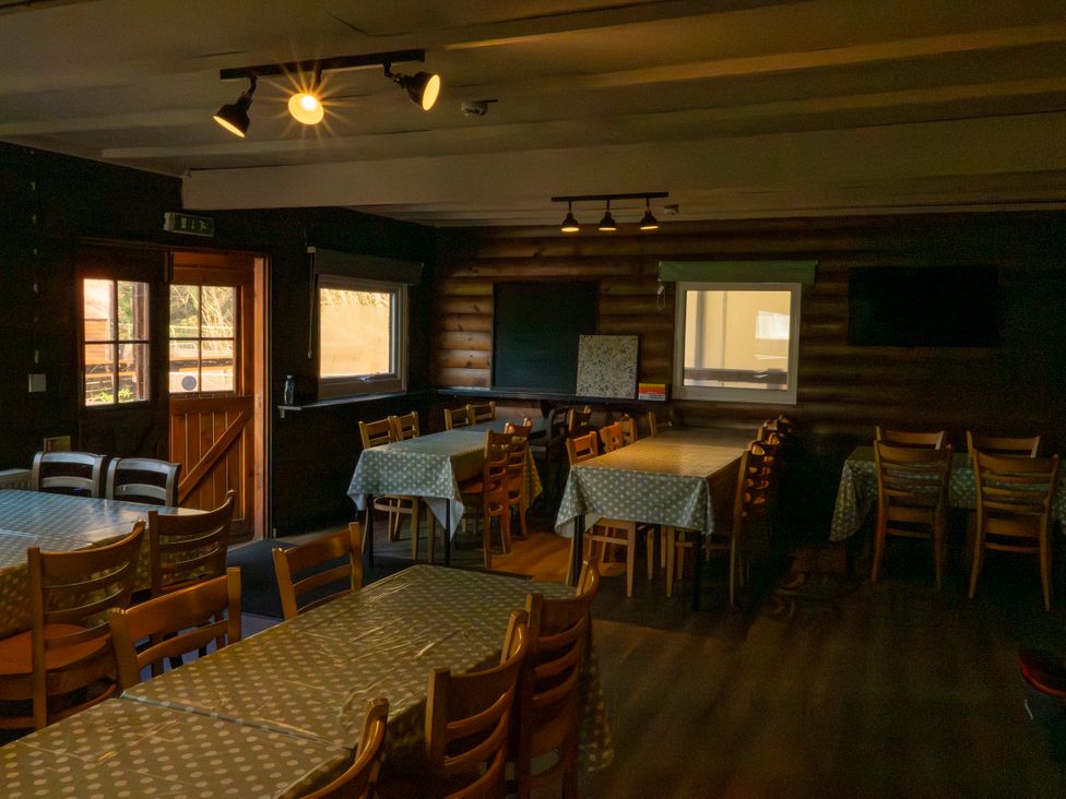 A dining room with tables and chairs at 2 Bedroom Chalet No.2 Port Talbot