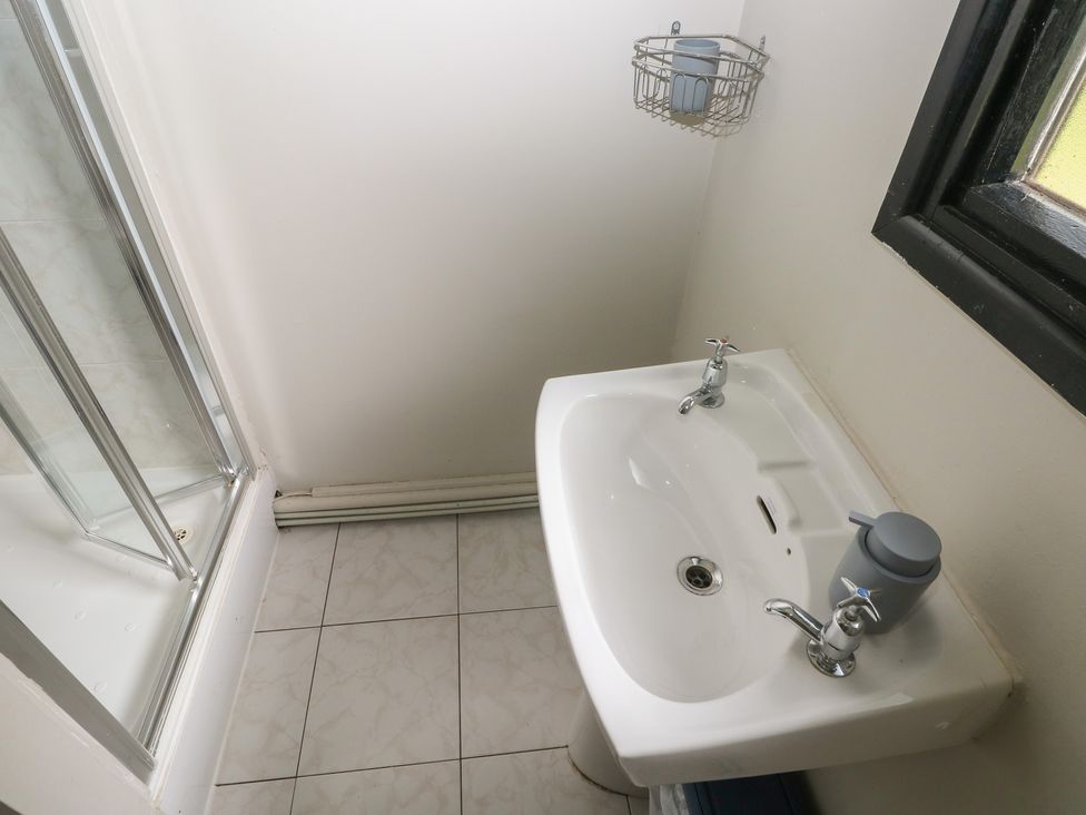 A bathroom with a sink and shower at Cabin No. 15 - Salt and Fern Cabins Goytre near Port Talbot