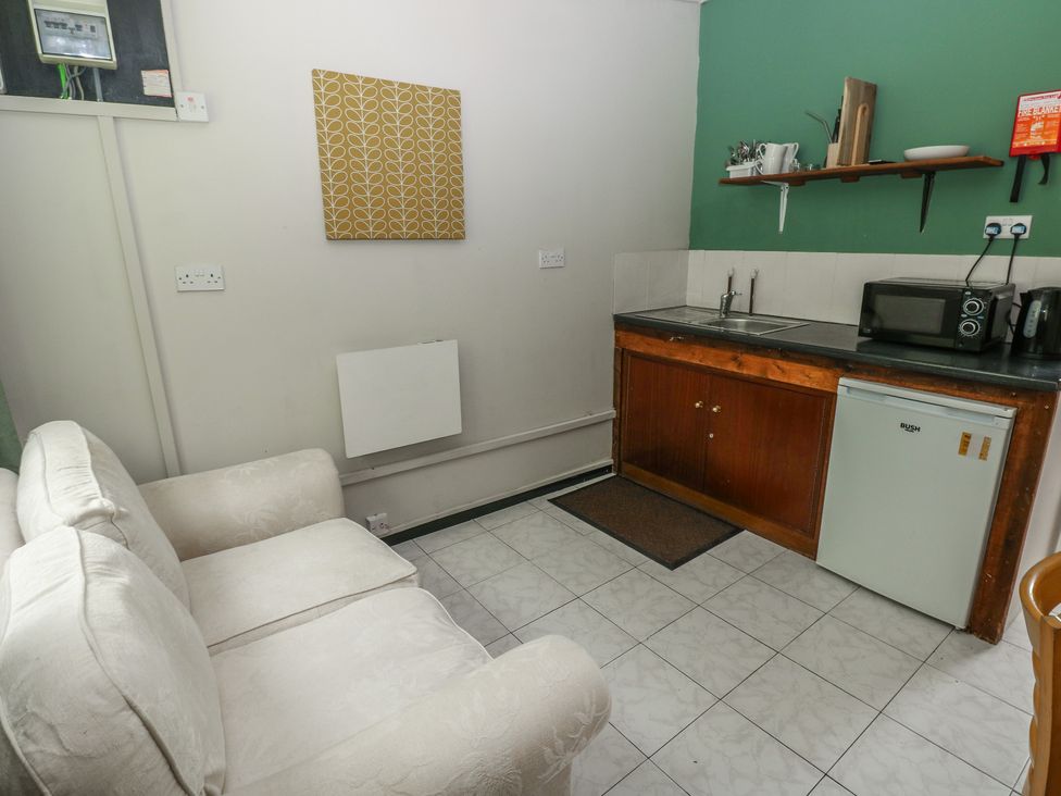 A kitchen with a sink and appliances at Cabin No. 16 - Salt and Fern Cabins Goytre near Port Talbot