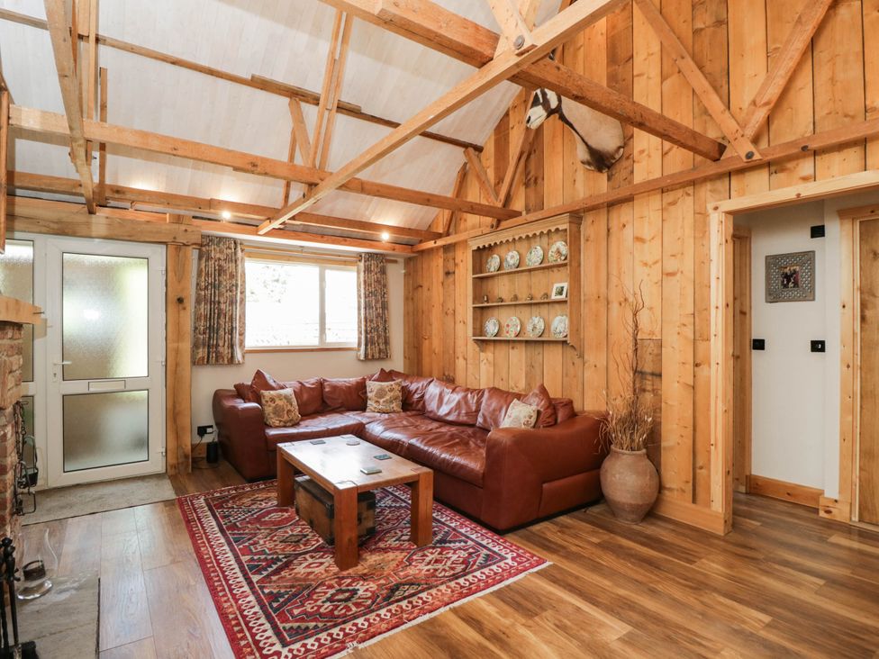 A living room with a couch and coffee table at Little Orchard in SwallowCliffe