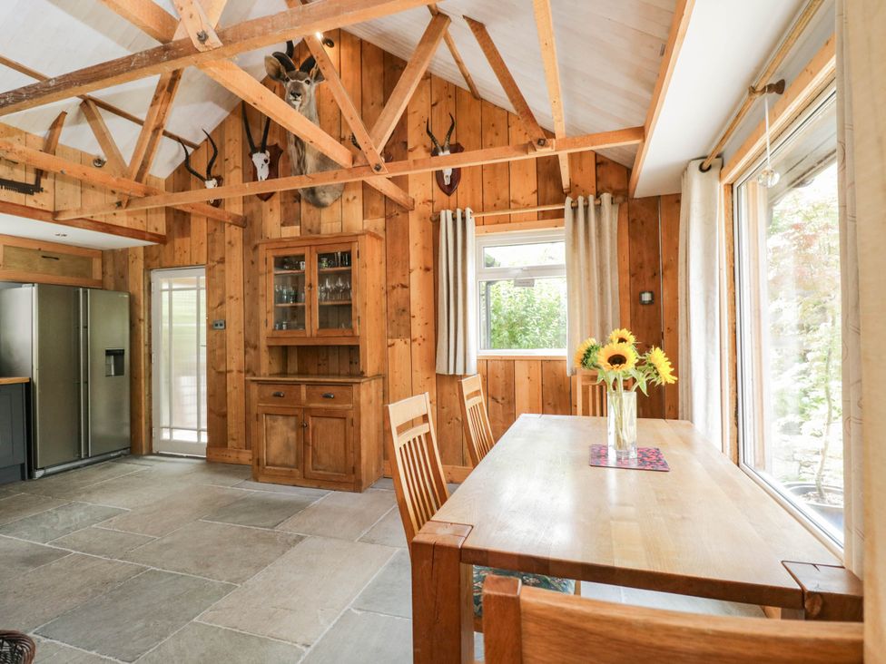 A kitchen with a dining table and chairs at Little Orchard in SwallowCliffe
