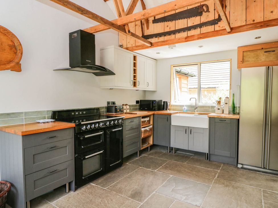 A kitchen with cabinets and a stove at Little Orchard in SwallowCliffe