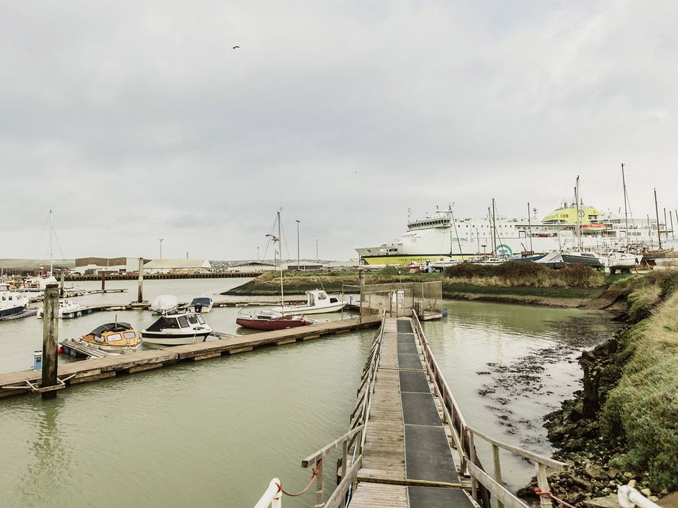 A harbor with boats and a ferry at 5 Mariners Wharf in Newhaven
