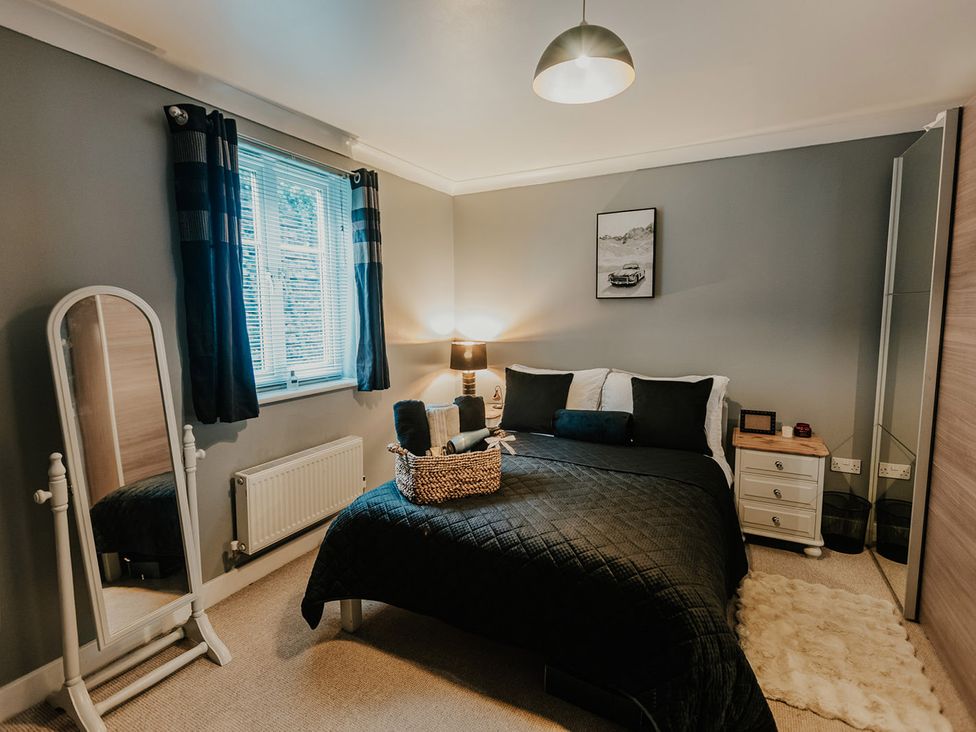 A bedroom with a bed and wardrobe at 5 Mariners Wharf in Newhaven