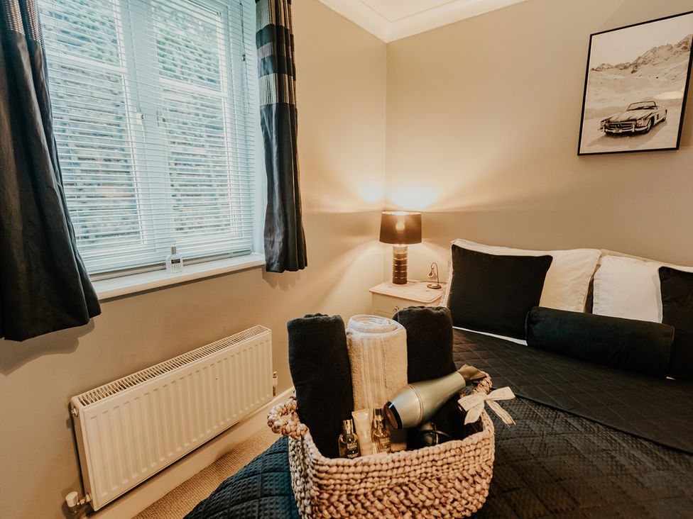 A bedroom with a bed and a lamp at 5 Mariners Wharf Newhaven