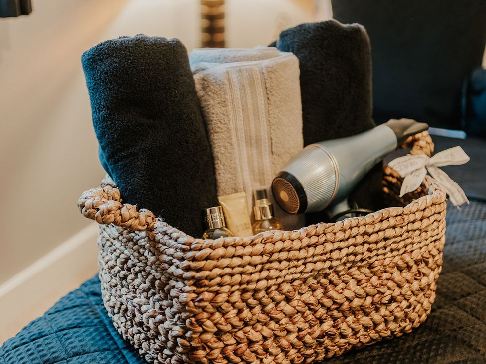 A basket containing towels and personal care items at 5 Mariners Wharf in Newhaven