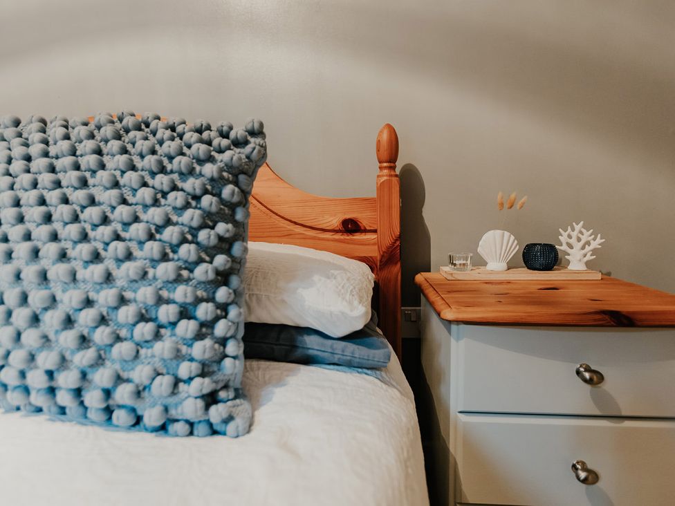 A bedroom with a bed and a nightstand at 5 Mariners Wharf Newhaven