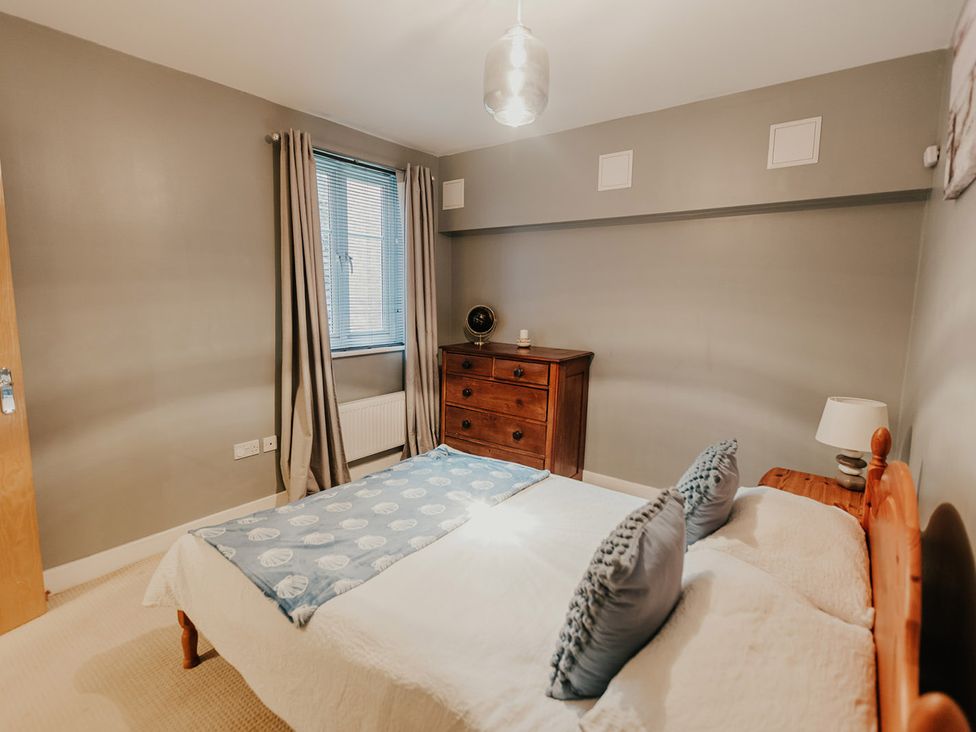 A bedroom with a bed and chest of drawers at 5 Mariners Wharf Newhaven