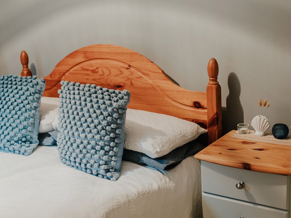 A bedroom with a bed and a nightstand at 5 Mariners Wharf Newhaven